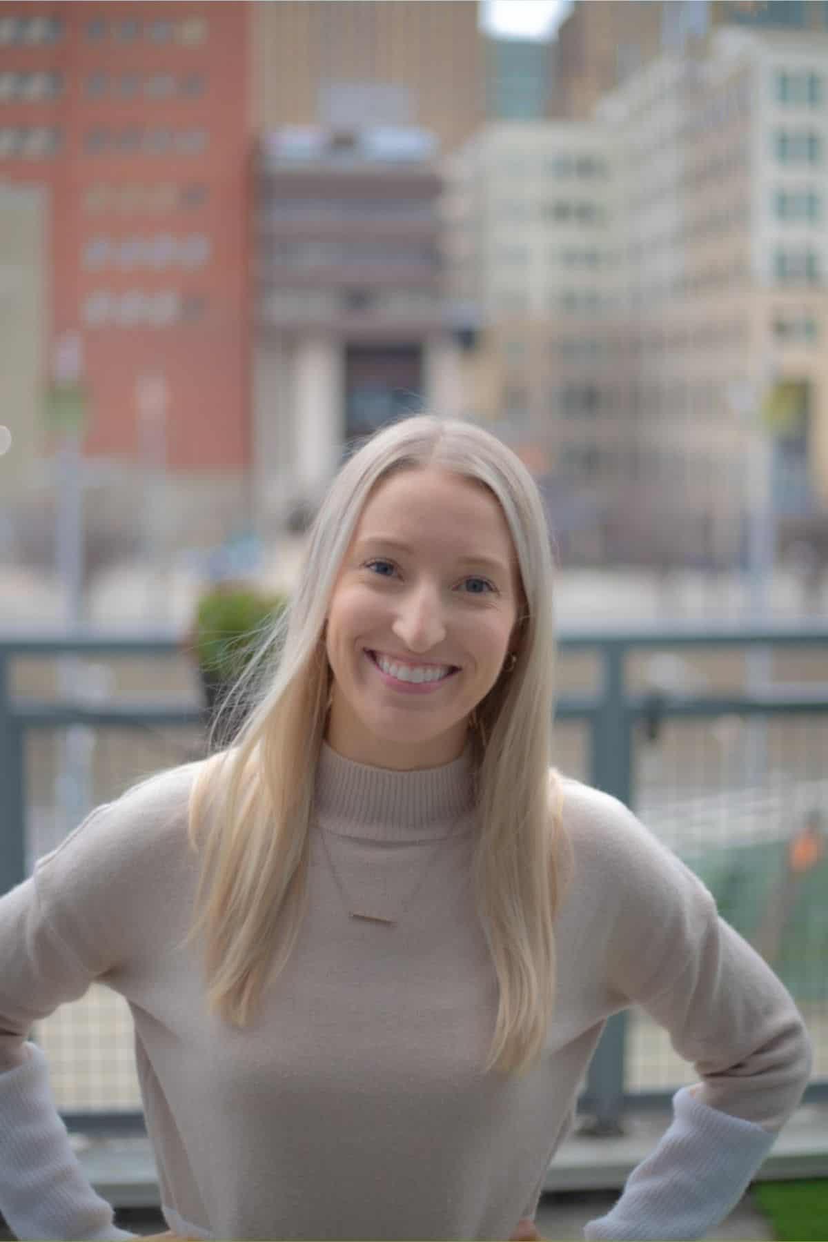 Headshot of Stephanie in a sweater standing outside smiling at the camera.