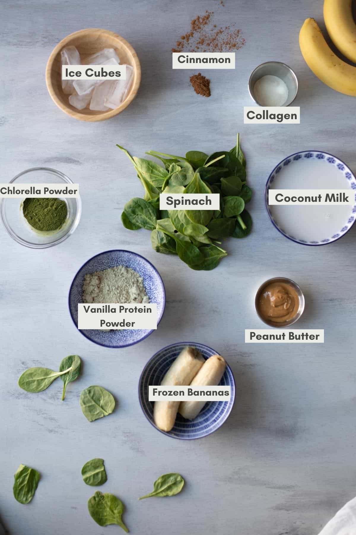 Top down view of the smoothie ingredients laying on a gray table.
