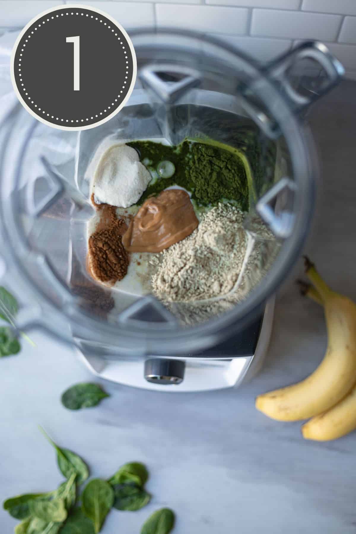 Top down view of a blender filled with wet and dry smoothie ingredients.