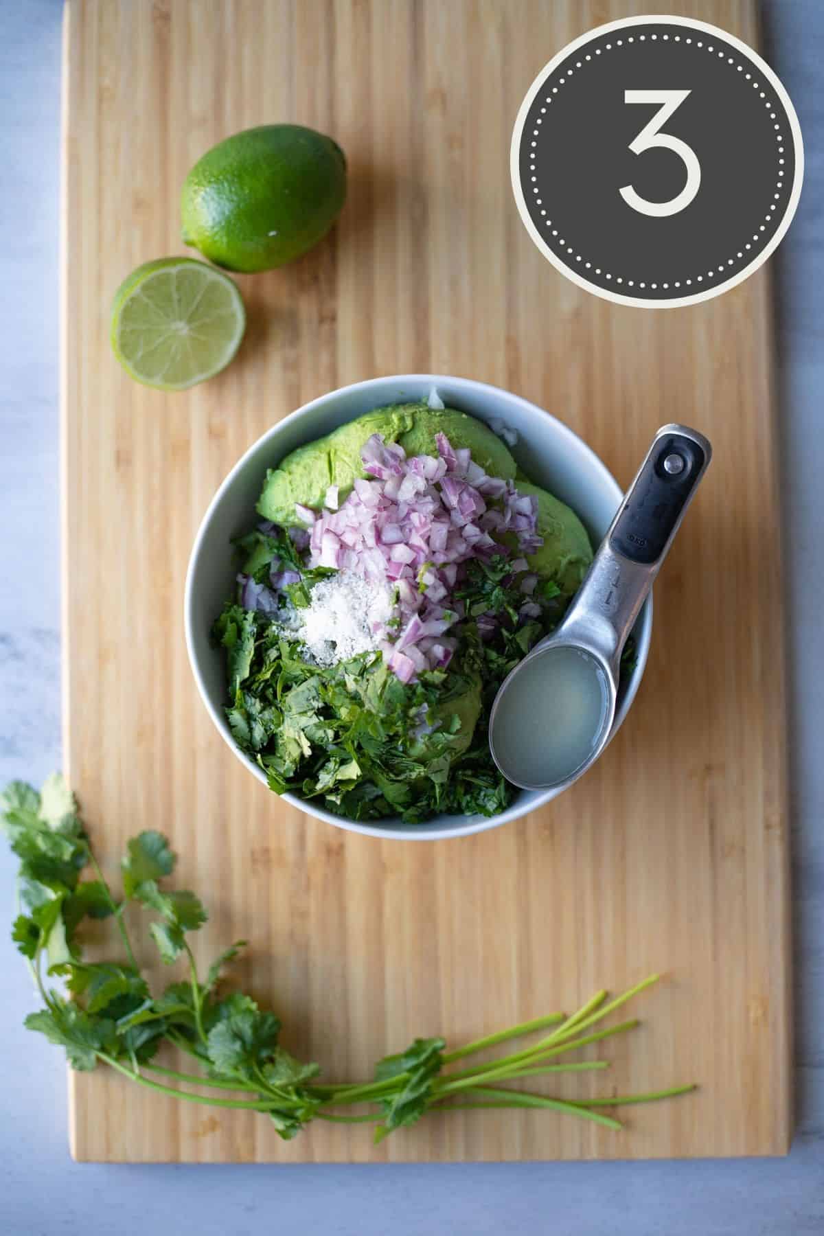 All the ingredients for the recipe in a white bowl on a wooden cutting board.